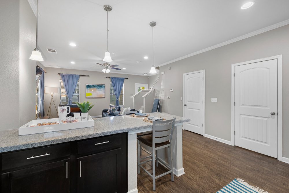 the collective at norman apartments near the university of oklahoma kitchen island to living room wood style flooring