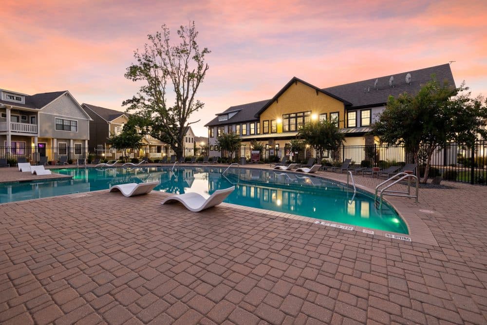 the collective at norman apartments near the university of oklahoma resort california style pool clubhouse exterior sunset